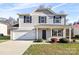 Two-story house with gray siding, black shutters, and landscaping at 109 Berrybeth Cir, China Grove, NC 28023