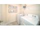 Bright laundry room with washer, dryer, and shelving at 114 Woodhall Way, Troutman, NC 28166