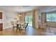 Farmhouse-style dining room with round table, metal chairs, and sliding glass doors at 118 Woodhall Way, Troutman, NC 28166