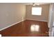 Light brown walls, hardwood floors, and a ceiling fan in a bedroom at 1646 Eagles Pl # H 101, Rock Hill, SC 29732