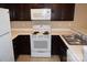 White appliances and dark brown cabinets in a galley kitchen at 1646 Eagles Pl # H 101, Rock Hill, SC 29732