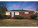 Brick ranch house with a landscaped yard and a spacious lawn at 2504 Juniper Dr, Charlotte, NC 28269