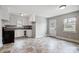 Eat-in kitchen with white cabinets, tile floor and exterior access at 2504 Juniper Dr, Charlotte, NC 28269