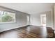 Living room with hardwood floors, grey walls and door to kitchen at 2504 Juniper Dr, Charlotte, NC 28269