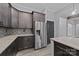 Modern kitchen with dark cabinets and stainless steel appliances at 2694 Woodcrest Sw Dr, Concord, NC 28027