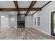 Spacious living room with exposed wooden beams, a stone fireplace, and LVP flooring at 2694 Woodcrest Sw Dr, Concord, NC 28027