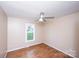 Simple bedroom with wood-look floors, a window, and ceiling fan at 3001 Austin Chaney Rd, Monroe, NC 28110