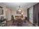 Elegant dining room with a glass table, chandelier, and hardwood floors at 4140 Trowel Ct, Midland, NC 28107