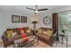 Cozy bonus room with two sofas, coffee table, and large clock at 4140 Trowel Ct, Midland, NC 28107