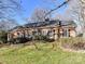 Brick ranch house with a landscaped lawn and mature trees at 4511 Twin Oaks Pl, Charlotte, NC 28212