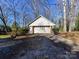 Two-car garage with brick facade and driveway at 4511 Twin Oaks Pl, Charlotte, NC 28212