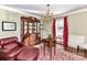 Cozy sitting area with a leather chair, wooden cabinet, and chandelier at 4511 Twin Oaks Pl, Charlotte, NC 28212