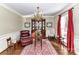 Cozy sitting area with a leather chair, a wooden cabinet, and a chandelier at 4511 Twin Oaks Pl, Charlotte, NC 28212