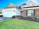 Brick and siding home with two-car garage and landscaped lawn at 5981 Bison Ct, Fort Mill, SC 29707