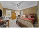 Bedroom with a wooden bed frame, a desk, and plenty of natural light at 599 Georgetown Nw Dr, Concord, NC 28027