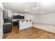 Modern kitchen with dark cabinets and a breakfast bar at 6204 Springbeauty Dr, Charlotte, NC 28227