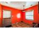 Small dining area with orange walls and tiled floor, near the kitchen at 6212 Snowcrest Ct, Charlotte, NC 28212