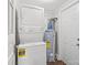 Laundry area with stackable washer and dryer, and water heater at 8532 Old Plank Rd, Charlotte, NC 28216