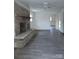 Living room with brick fireplace and gray laminate floors at 111 Dye St, Chester, SC 29706