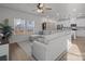 Open living room with L-shaped sofa and view of kitchen at 1124 Jeffery Dean Ct, Albemarle, NC 28001