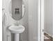 Small powder room with pedestal sink and round mirror at 1124 Jeffery Dean Ct, Albemarle, NC 28001