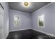 Bright bedroom with dark hardwood floors and two windows at 419 E Fisher St, Salisbury, NC 28144