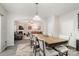 Bright dining room with wooden table and access to kitchen at 4836 Pepper Dr, Harrisburg, NC 28075