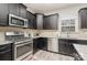 Modern kitchen with dark cabinets and stainless steel appliances at 4836 Pepper Dr, Harrisburg, NC 28075