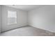 Simple bedroom with grey carpet and window at 542 Stroupe Rd, Gastonia, NC 28056