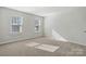 Bright bedroom with carpet flooring and two large windows at 6707 W Sugar Creek Rd, Charlotte, NC 28269