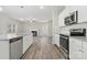 Modern kitchen with white cabinets, granite counters, and island at 6707 W Sugar Creek Rd, Charlotte, NC 28269