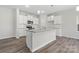 Modern kitchen with white cabinets, granite counters, and island at 6707 W Sugar Creek Rd, Charlotte, NC 28269