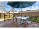 Relaxing backyard deck with patio furniture and umbrella at 7613 Rolling Meadows Ln, Huntersville, NC 28078