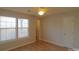 Bright bedroom with hardwood floors, ceiling fan, and double windows at 8121 #E Tremaine Ct, Charlotte, NC 28227