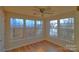 Sunroom with hardwood floors, multiple windows, and ceiling fan at 8121 #E Tremaine Ct, Charlotte, NC 28227
