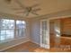 Sunroom with hardwood floors, French doors, and view of living room at 8121 #E Tremaine Ct, Charlotte, NC 28227