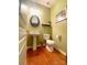 Powder room with pedestal sink and hardwood floors at 904 Lyndley Dr, Fort Mill, SC 29708