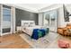 Spacious primary bedroom with plush bedding and a sitting area at 104 Mattoon St, Charlotte, NC 28216