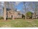 Brick home nestled amongst mature trees on a spacious lot at 11613 Old Surry Ln, Charlotte, NC 28277