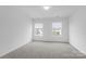 Spacious bedroom with gray carpet and two windows at 1503 Autumn Banks Way # 1P, High Shoals, NC 28077