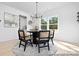 Bright dining room with round table and six chairs, stylish chandelier, and large mirror at 1505 Autumn Banks Way # 2P, High Shoals, NC 28077