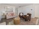 Living room features a beige sofa, two brown armchairs, and a gold coffee table at 1731 Long Paw Ln, Charlotte, NC 28214