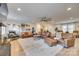 Living area featuring leather sofas, a stone fireplace, and large windows at 402 Lake Shore Dr, Fort Mill, SC 29715