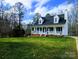 White charming one-story house with a nice lawn and mature trees at 532 Rutledge Dr, Catawba, SC 29704