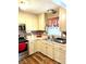 Galley-style kitchen with light-colored cabinets and updated flooring at 118 Carr Rd, Dallas, NC 28034