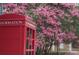 Classic red telephone booth with blooming crape myrtles in the background at 118 Shorecrest Dr, Davidson, NC 28036