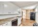 Open kitchen with granite countertops, black appliances, and wood-look flooring at 1337 Eisenhower Rd, Rock Hill, SC 29730