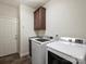 Laundry room with washer, dryer, and storage cabinet at 150 Abbington Pl, Locust, NC 28097