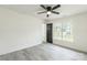 Bedroom with ceiling fan, grey laminate floors, and exterior door access at 1656 Baylor Dr, Rock Hill, SC 29732