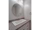 Bathroom with a vanity, round mirror, and white fixtures at 16967 Turning Stick Ct, Charlotte, NC 28213